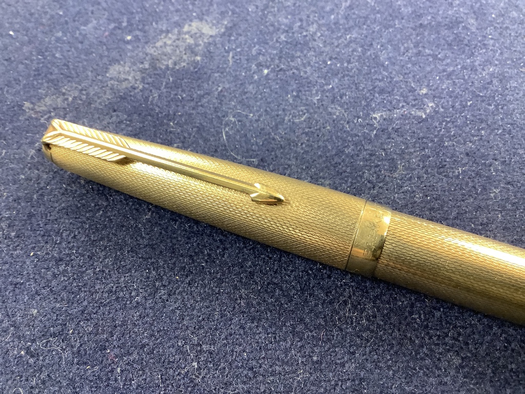 Five assorted pens to include a 9ct gold Parker